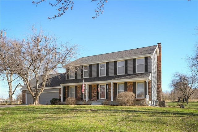 colonial inspired home with a front lawn, covered porch, and a garage