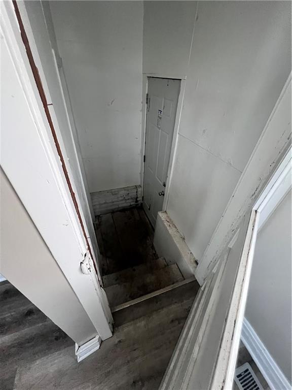 stairs featuring hardwood / wood-style floors