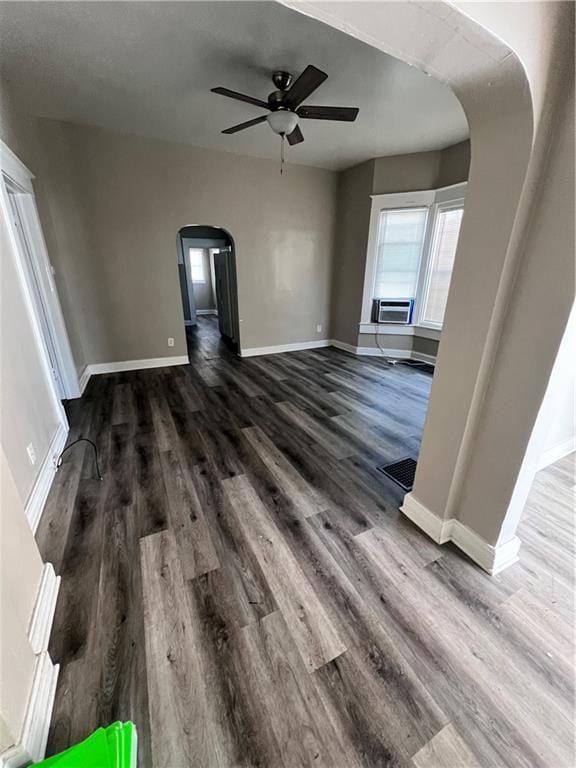 unfurnished living room with ceiling fan and dark hardwood / wood-style flooring