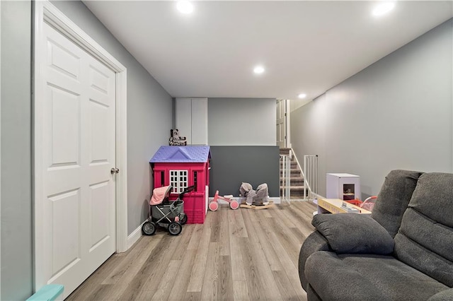 rec room with light hardwood / wood-style floors