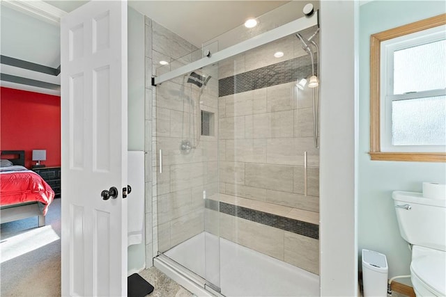 bathroom with toilet and a shower with shower door