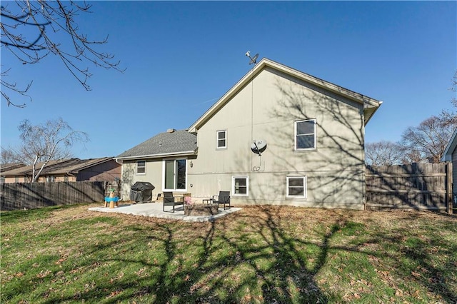 rear view of property with a lawn and a patio