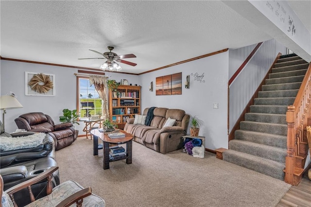 carpeted living room featuring ceiling fan, crown molding, and a textured ceiling