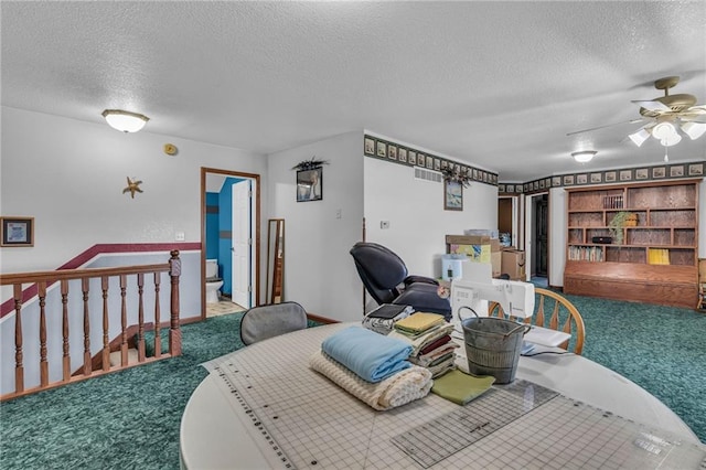 dining room featuring carpet flooring, a textured ceiling, and ceiling fan
