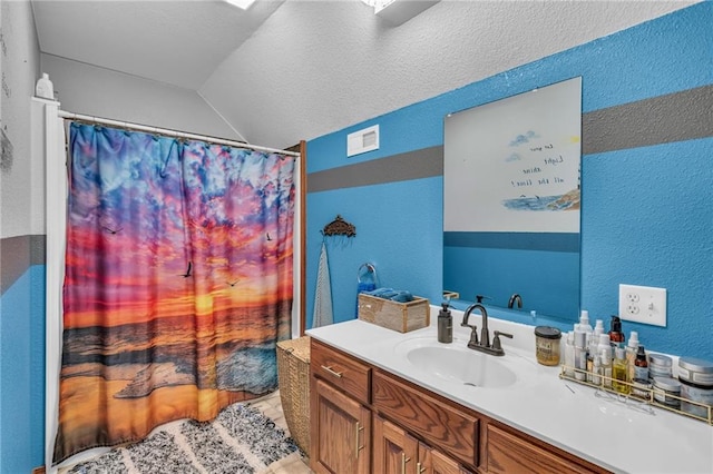 bathroom featuring tile patterned floors, vanity, and lofted ceiling