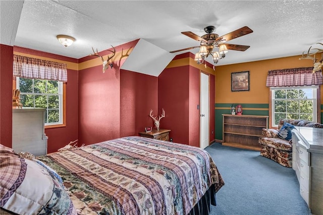 carpeted bedroom with ceiling fan, a textured ceiling, and ornamental molding