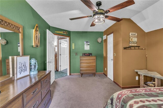 bedroom with carpet flooring, a textured ceiling, vaulted ceiling, and ceiling fan