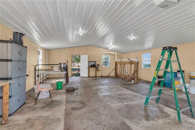 misc room with concrete floors and vaulted ceiling