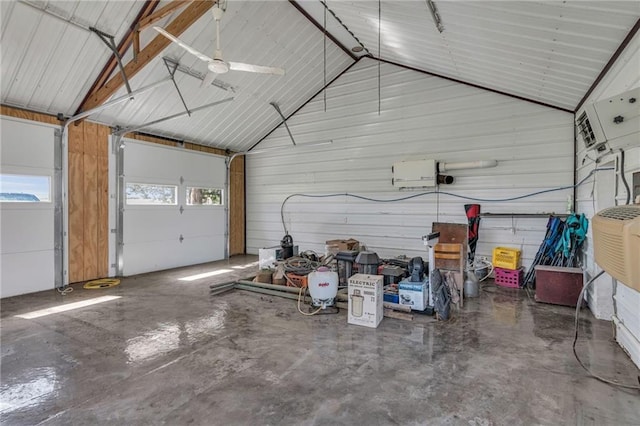 garage with ceiling fan and wooden walls