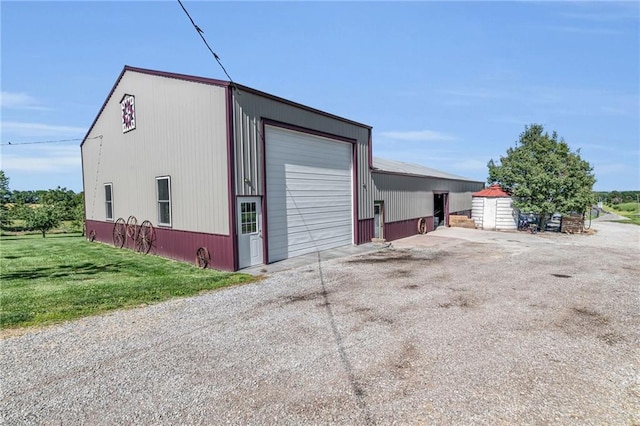 garage featuring a lawn