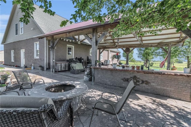view of patio featuring a gazebo and an outdoor fire pit