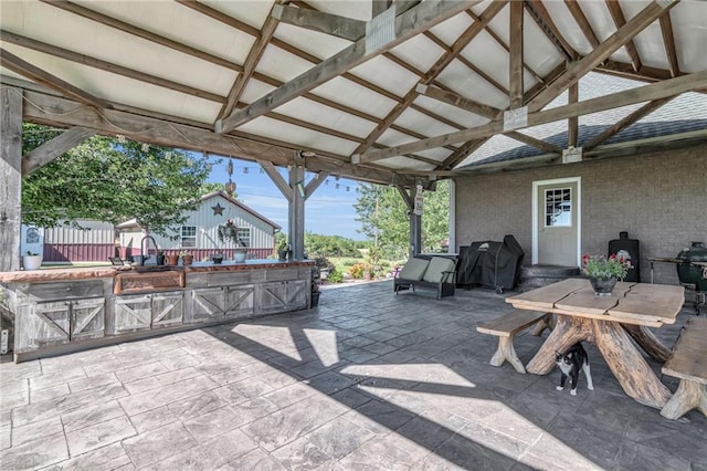 view of patio featuring a gazebo, an outdoor kitchen, and grilling area
