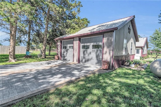 view of outbuilding with a garage and a lawn