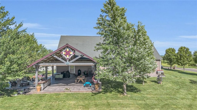 rear view of property featuring a yard and a patio