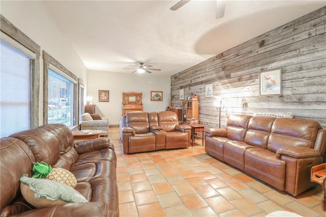 living room featuring wooden walls, light tile patterned flooring, and vaulted ceiling