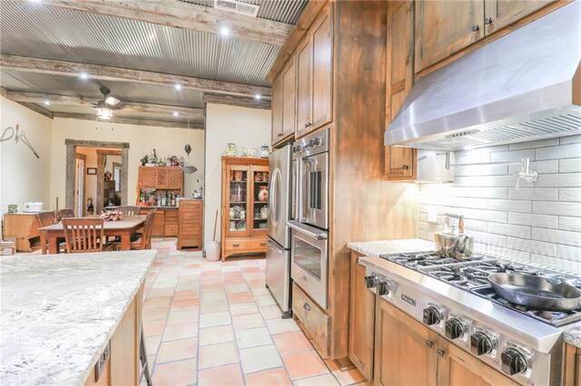 kitchen featuring decorative backsplash, ceiling fan, light stone countertops, appliances with stainless steel finishes, and beamed ceiling