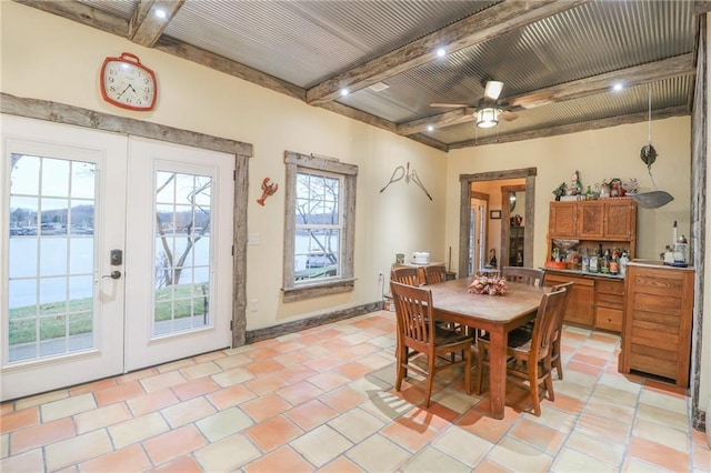 tiled dining area with ceiling fan, french doors, and beamed ceiling