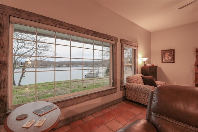 interior space with a water view and light tile patterned floors