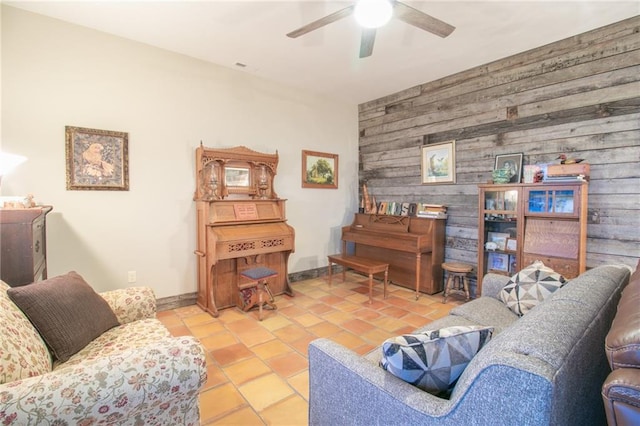 living room with ceiling fan and light tile patterned flooring