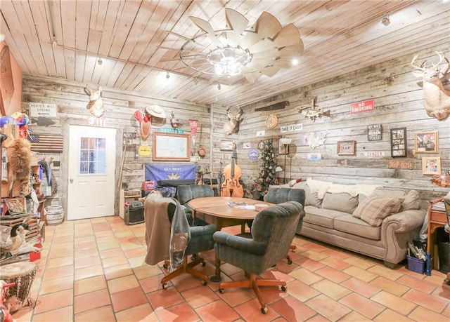 dining area featuring ceiling fan, wooden walls, and wood ceiling