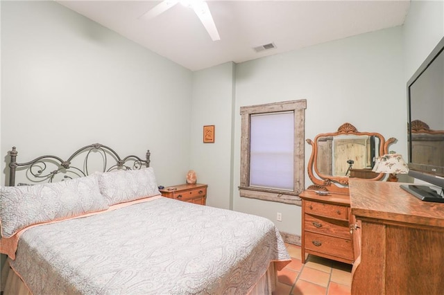 tiled bedroom featuring ceiling fan