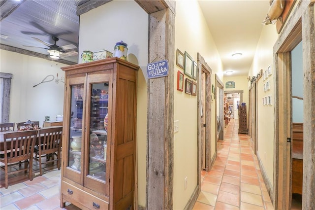 hallway featuring a barn door and light tile patterned flooring