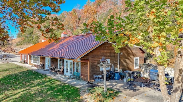 back of house featuring french doors, a yard, and a patio area