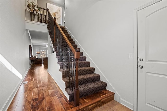 stairs featuring hardwood / wood-style flooring