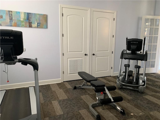 workout area with dark colored carpet