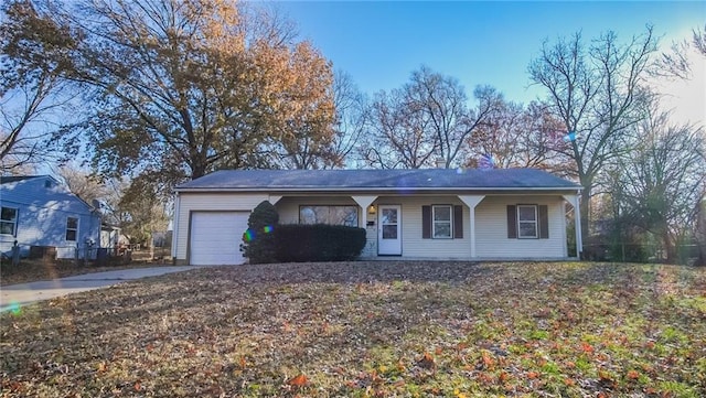 ranch-style home with a porch and a garage