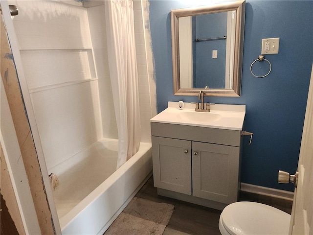 full bathroom with hardwood / wood-style floors, vanity, shower / bath combination with curtain, and toilet