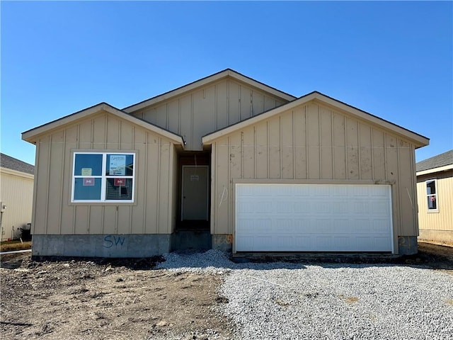 view of front of home featuring driveway, board and batten siding, and an attached garage