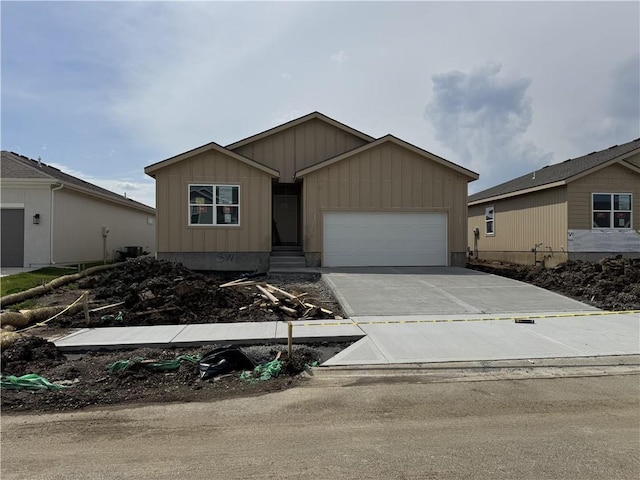 17756 Houston St, Gardner, KS 66030 - view of front of house featuring board and batten siding, a garage, and driveway