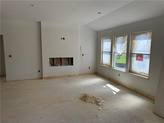 17756 Houston St, Gardner, KS 66030 - unfurnished living room featuring lofted ceiling and baseboards