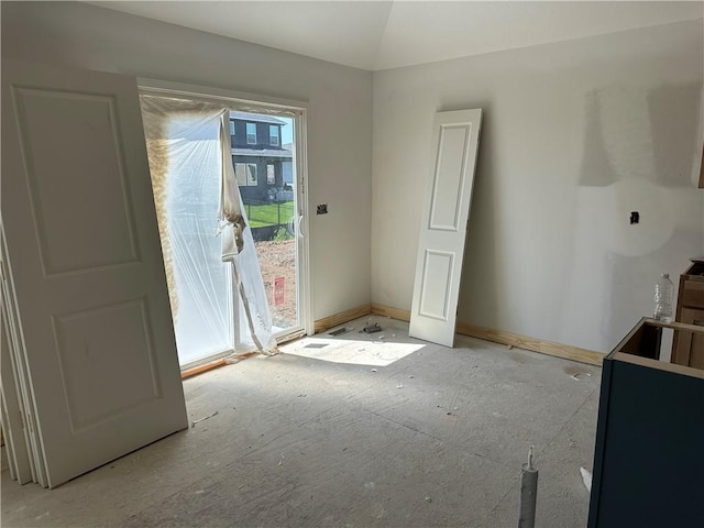 17756 Houston St, Gardner, KS 66030 - unfurnished dining area featuring lofted ceiling and baseboards