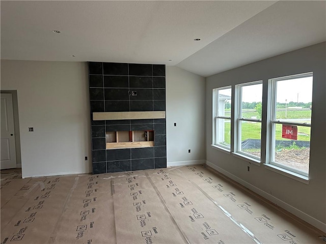 17756 Houston St, Gardner, KS 66030 - unfurnished living room featuring lofted ceiling and a fireplace