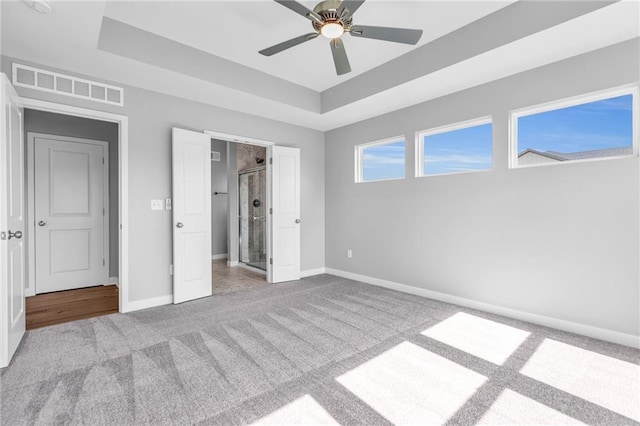 17756 Houston St, Gardner, KS 66030 - unfurnished bedroom featuring carpet flooring, a tray ceiling, and ceiling fan