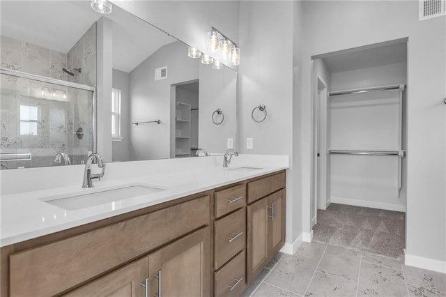 17756 Houston St, Gardner, KS 66030 - bathroom with vaulted ceiling, double vanity, a shower stall, and a walk in closet
