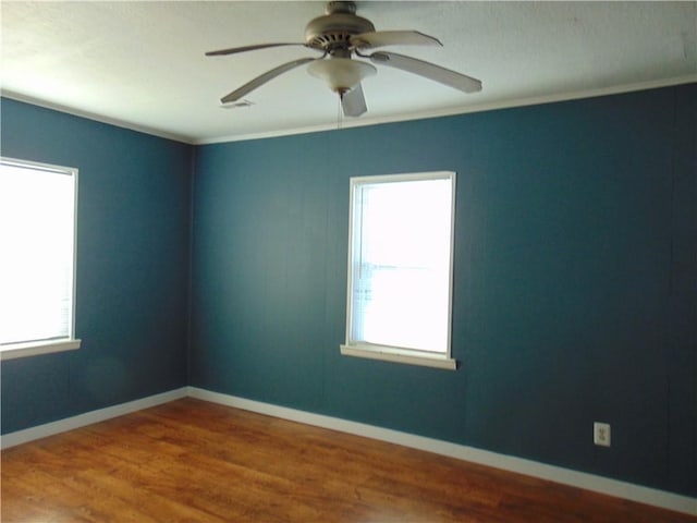 unfurnished room featuring crown molding, hardwood / wood-style floors, and ceiling fan