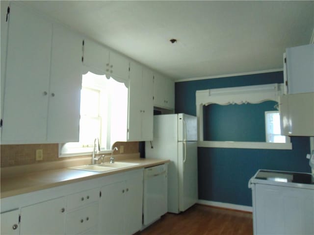 kitchen with sink, dark hardwood / wood-style flooring, backsplash, white appliances, and white cabinets