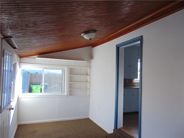 empty room featuring wood ceiling, carpet floors, and vaulted ceiling