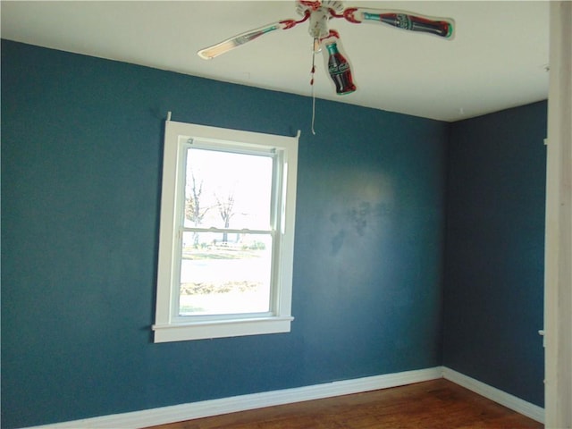 spare room featuring wood-type flooring and ceiling fan