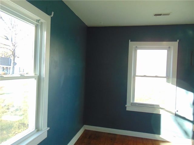 unfurnished room with dark hardwood / wood-style flooring