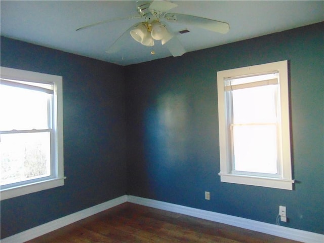 empty room featuring ceiling fan and dark hardwood / wood-style floors