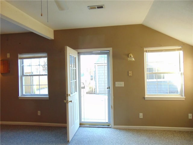 doorway to outside with carpet, a healthy amount of sunlight, and lofted ceiling