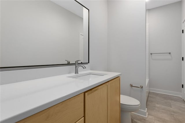 full bath with toilet, baseboards,  shower combination, and vanity