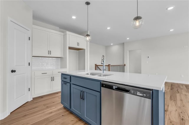 kitchen featuring blue cabinetry, sink, dishwasher, an island with sink, and white cabinets