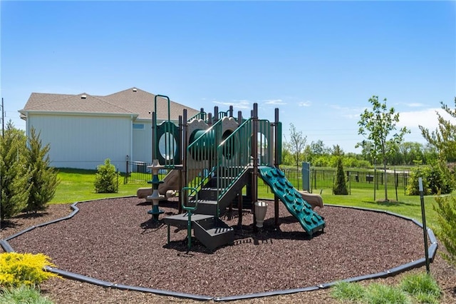 community play area featuring fence and a lawn