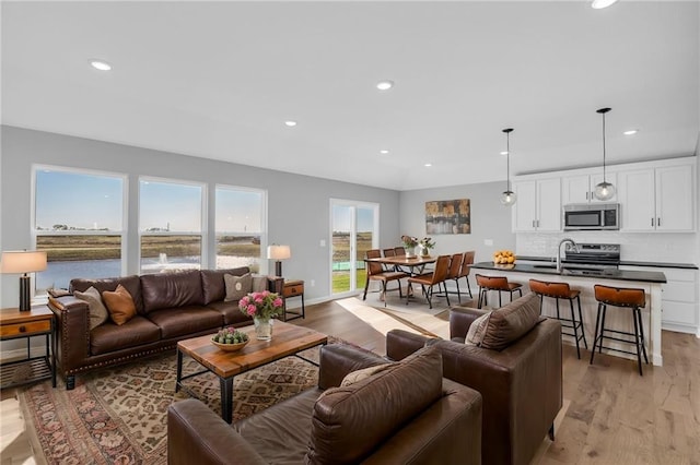17752 Houston St, Gardner, KS 66030 - living room featuring recessed lighting, light wood-type flooring, and a water view