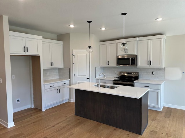17752 Houston St, Gardner, KS 66030 - kitchen with stainless steel appliances, light wood-style floors, light countertops, and recessed lighting